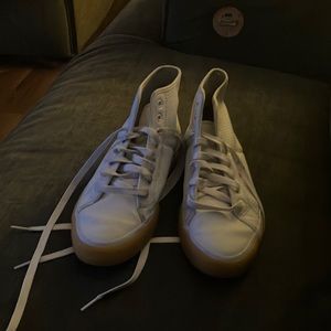 White DCs size 9 1/2 shoe ankle high with a light brown trim around the front.